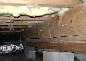sagging crawl space with wooden shimming a Bountiful crawl space