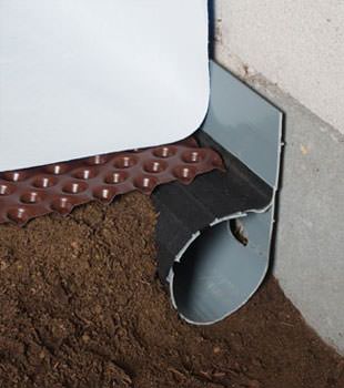 Closeup of a crawl space drainage system installed in Brigham City