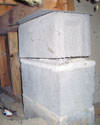 Concrete crawl space support posts in American Fork that are showing signs of failure as they sink into the earth.