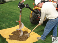 Auguring a hole in the earth for a foundation repair in Clearfield
