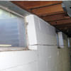 A foundation showing severe inward buckling along the windows in a Roy home.