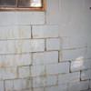 A cracked foundation wall near a window in a Lehi home