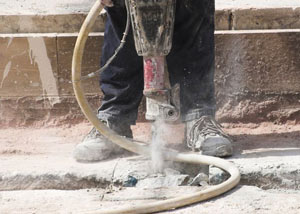 Jackhammering a slab floor in a Saratoga Springs home.