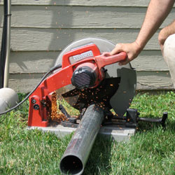 Cutting the support beam for a crawl space jack post outside a Sandy home.
