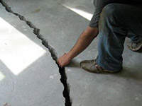 a severely damaged cracked concrete slab floor in Cedar City