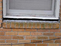 A window sill cracking and separating from the foundation wall in a Midvale home.