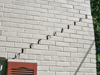 Stair-step cracks showing in a home foundation in Kaysville
