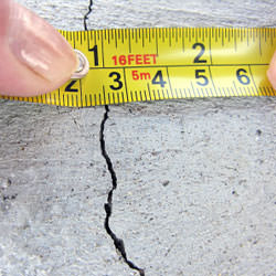 A crack in a poured concrete wall that's showing a normal crack during curing in Springville