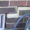 A closeup of a failed tuckpointing job where the brick cracked on a Centerville home.