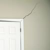 A long drywall crack beginning at the corner of a doorway in a Cedar City home.