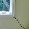 A long, diagonal crack that begins at a window corner of a South Jordan home