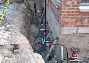 Foundation push piers installed around a house with a foundation settlement issues in Brigham City