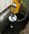 Installing a helical pier during a foundation repair in Provo