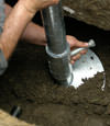 Provo helical pier installation nearing completion, with the blade being advanced into the foundation soils.