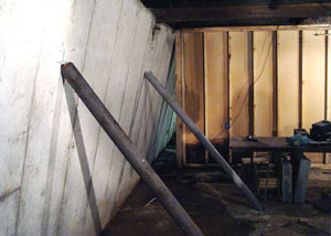 A severely tilting foundation wall propped up by steel beams in Centerville.