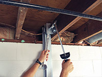 Straightening a foundation wall with the PowerBrace™ i-beam system in a Orem home.