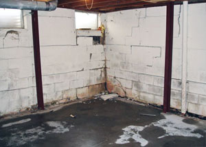A failed, rusty i-beam foundation wall system installed in Brigham City.