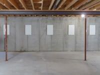 A repaired basement wall with foundation wall anchor covers installed in Saratoga Springs.