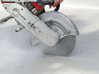 Cutting the driveway for expansion joints during street creep repair in Riverton