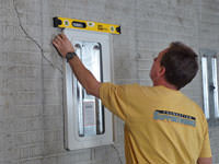 Positioning a wall plate cover on a foundation wall in Tooele.