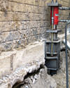 A completed installation of foundation push piers lifting a foundation in Riverton