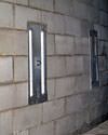 an inside view of foundation wall anchors installed along a basement wall to brace and repair the structure in Bountiful