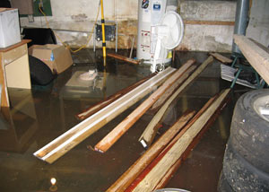 A severely flooding basement in Sandy, with lumber and personal items floating in a foot of water