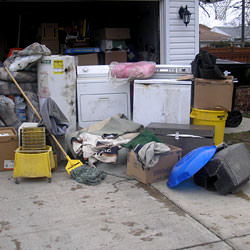 Soaked, wet personal items sitting in a driveway, including a washer and dryer in Tooele.