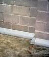 Our baseboard drain system installed on a corner in a Sandy basement.