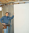 Installing wall panels on top of our basement wall insulation in Tooele