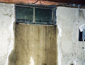 Water pouring out from a basement window in Draper