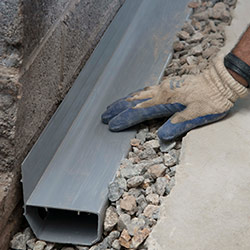 installing a drain tile system in a Pleasant Grove home